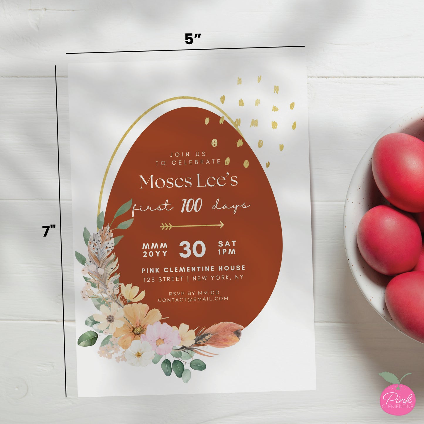 Red egg and ginger baby shower editable invitation template. Design features large red egg with boho style flower and feathers with faux gold elements. 5"x7" dimensions indicated.