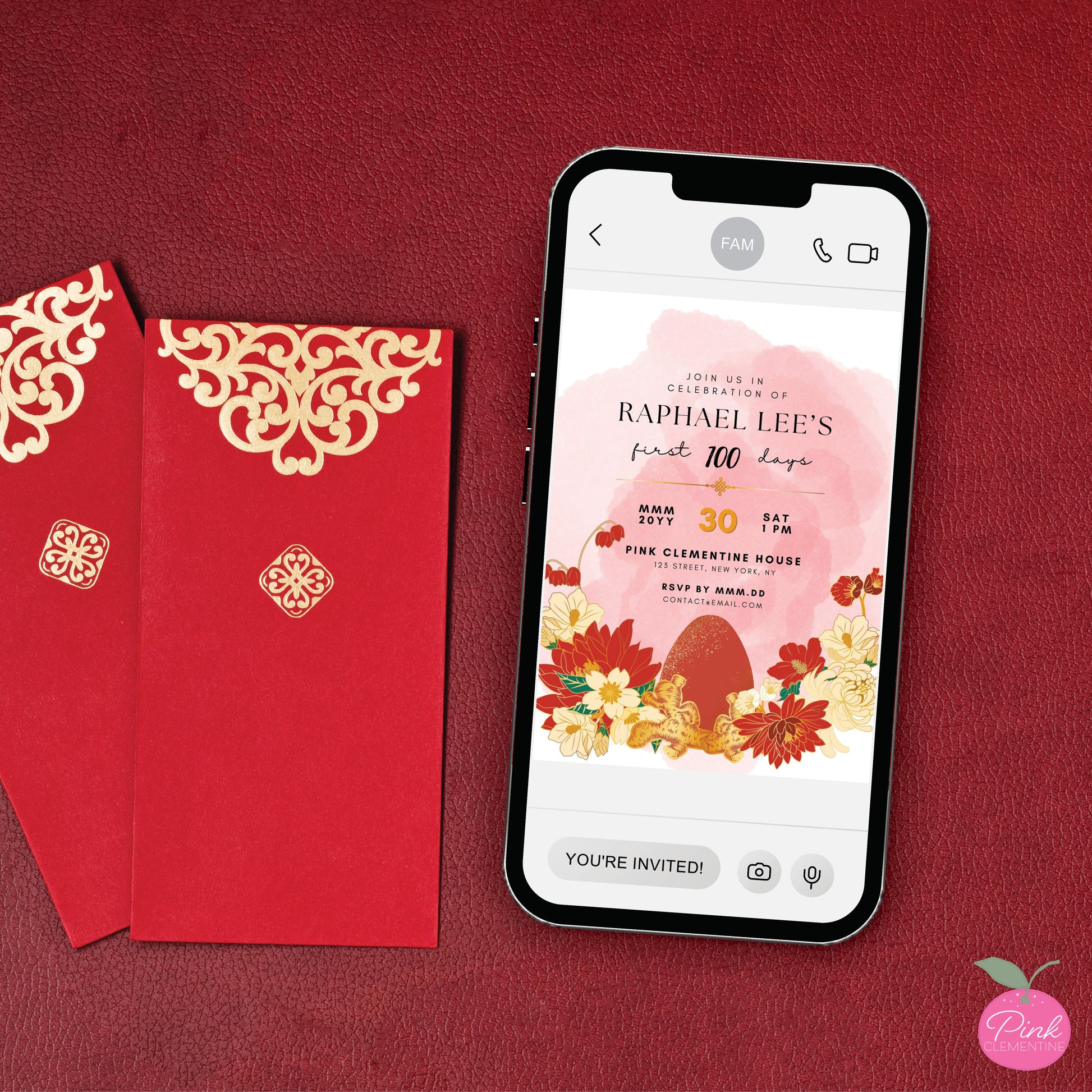 Red egg and ginger baby shower invitation displayed on a phone. Editable template features red and ivory chrysanthemum flowers with faux gold accents.